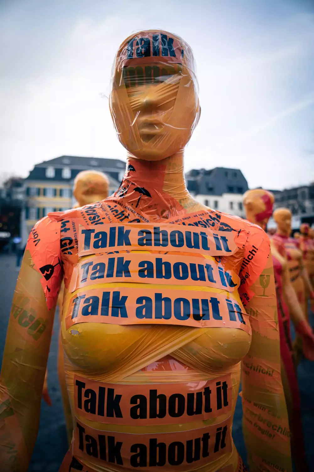 mannequin with tape that says 'Talk about it'